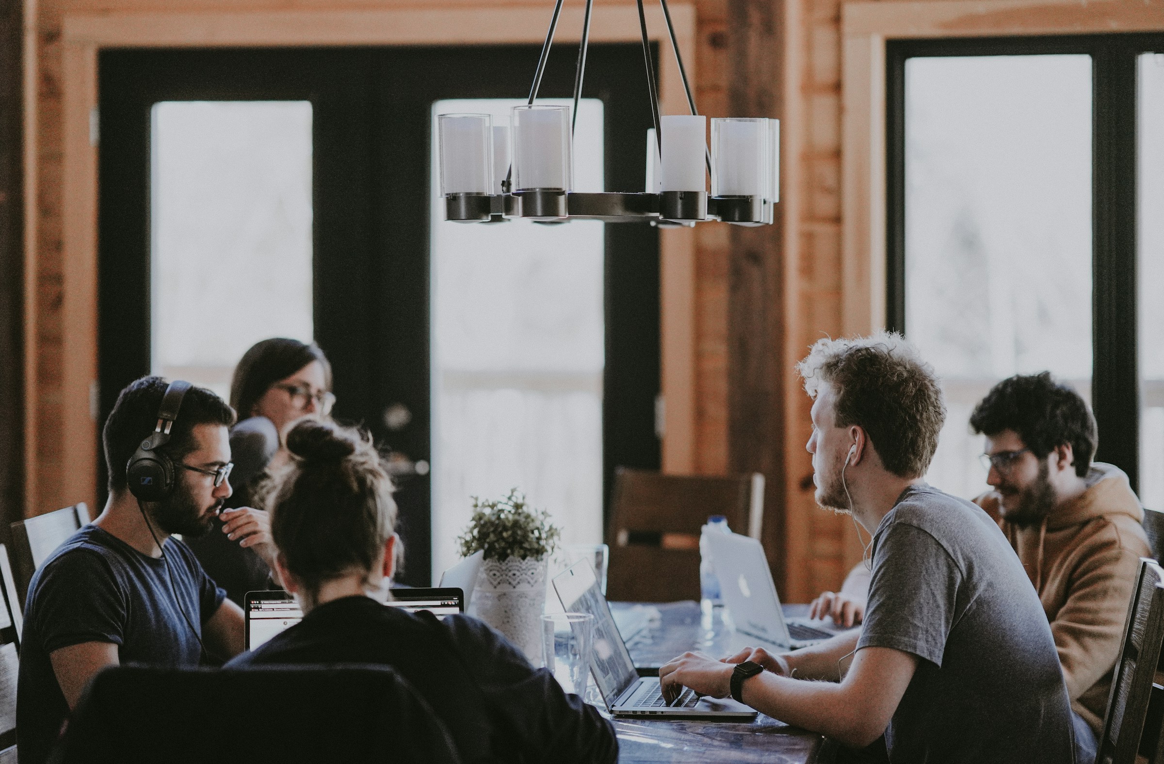 People collaborating on ideas around a shared work table
